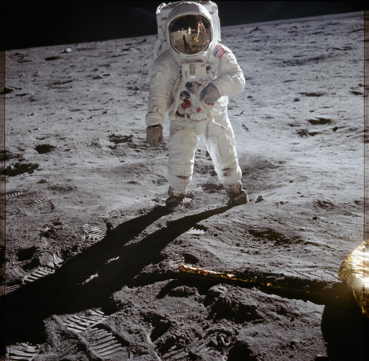 Buzz Aldrin on the lunar surface, with the photographer reflected in his visor.